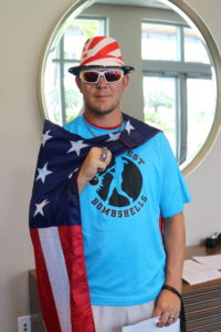 Brandon Chesser of the Austin Blackhawks wearing his Bombshells jersey, American flag cape, american flag fedora, sunglasseses and World Series rings.