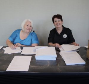 Sylvia Redman and Kathy Quinn checking people in at General Assembly to vote.