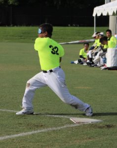 Tiny Chang, #32 for Taiwan Homerun, hitting the ball.