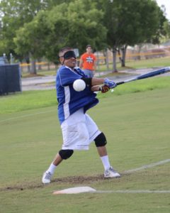 Lonestar Roadrunner Ozzy Calamaco swings with all his might while the ball seems to have gone right through his bat.