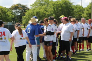 Lonestar Roadrunners and Rochester Pioneers shaking hands at the end of a game.