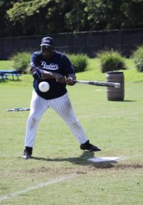 Braulio Thorne with the Long Island Bombers about to make contact with the ball that is almost to his bat.