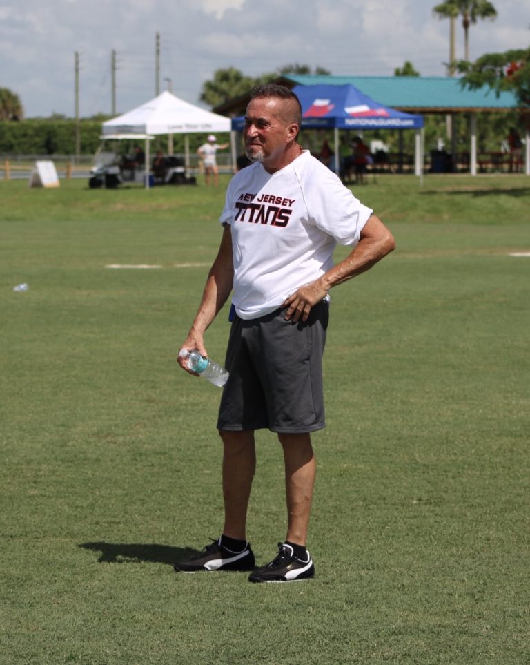 A New Jersey Titan smiles as he watches the game from the sidelines.