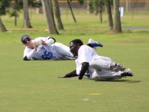 Player with Colorado Storm making an out as his teammate listens beside him.