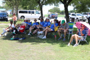 Spectators sitting in lawn chairs watching the games.