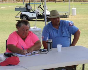 Umpire David Robert' sits with one of our hard working score keepers as she tallies up the score.