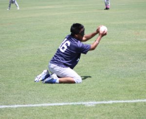 As he gets up on his knees, #16 Miguel Tello makes the out for the Indy Thunder.