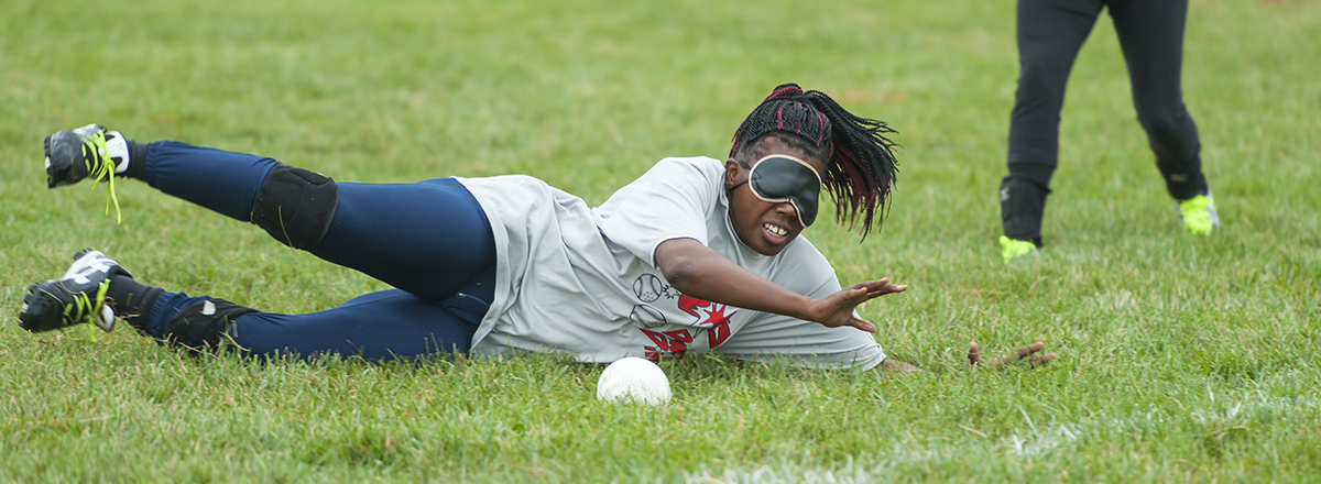 Kalari dives to field a beep baseball.