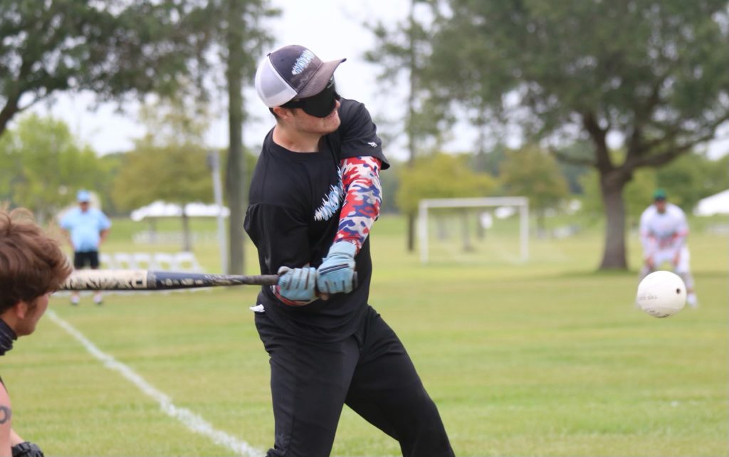 Justin Holland bringing his bat around as the ball comes to him right before he hit the first home run.