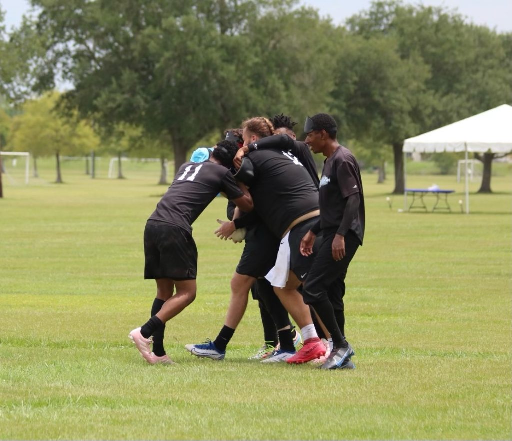 Kyle Kennedy with a few teammates hugging right after they won