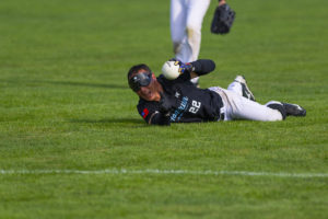 Taiwan Homerun's Andy Tsai laying on his stomach holding up ball and yelling